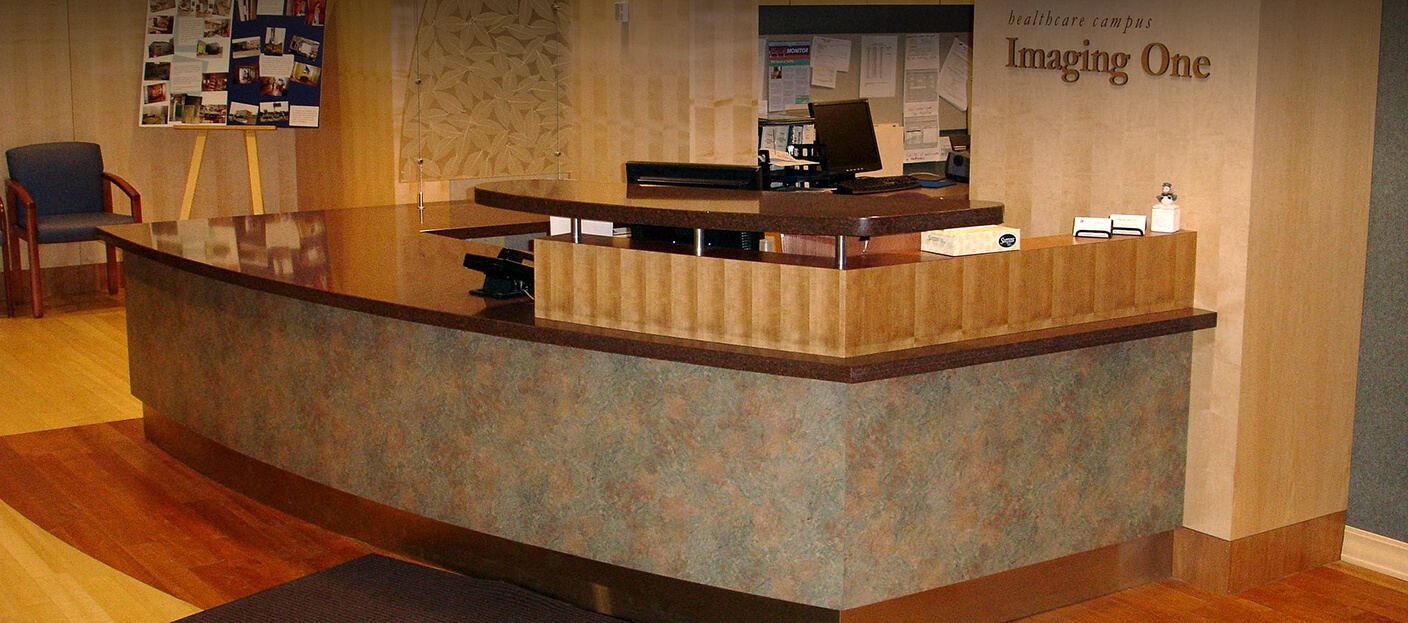 Custom engineered and fabricated reception desk created by Southern Minnesota Woodcraft for Imaging One 